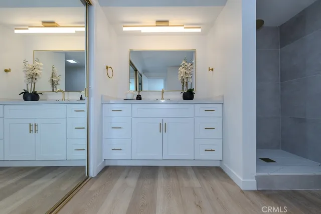 a spacious bathroom with a granite countertop sink a mirror and a