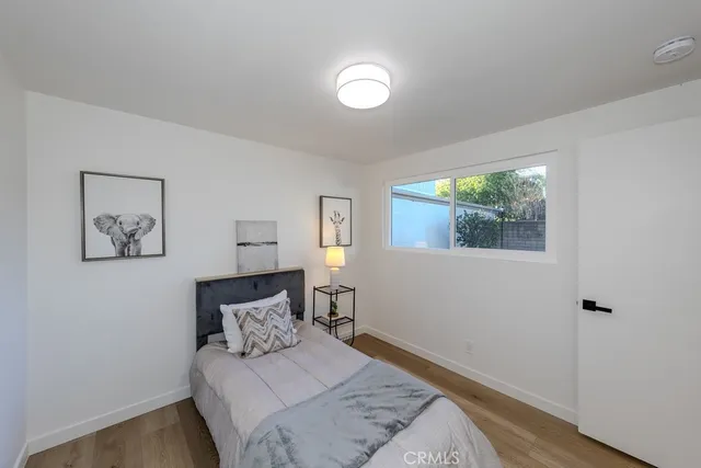 a bed sitting in a bedroom next to a window
