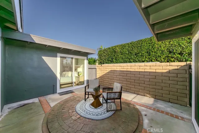 a view of a patio with table and chairs and potted plants
