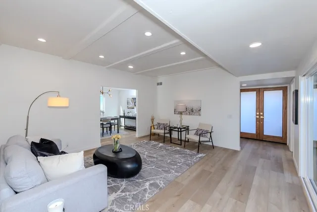 a living room with furniture and wooden floor