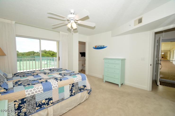 8700 Ridgewood Avenue, Unit B310 Cape Canaveral, FL 32920 - Photo 16 of 23 a bedroom with a large bed and a window