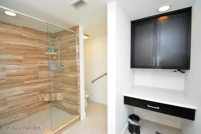a bathroom with a shower and a sink
