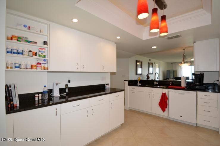 8700 Ridgewood Avenue, Unit B310 Cape Canaveral, FL 32920 - Photo 5 of 23 a kitchen with counter top space cabinets and appliances