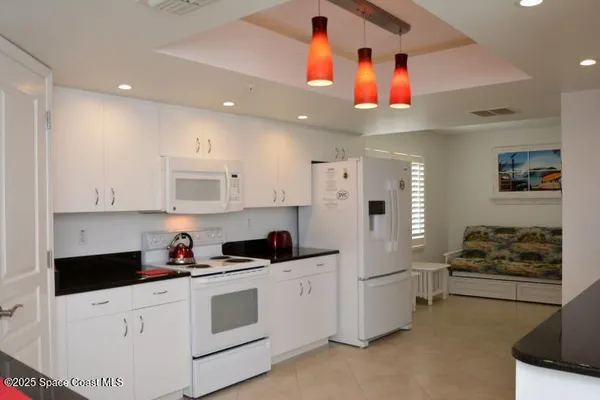 a kitchen with stainless steel appliances kitchen island a sink a stove and cabinets