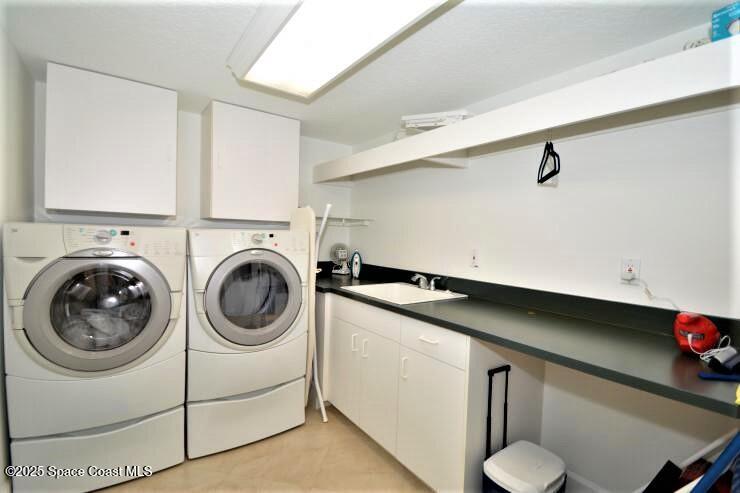 8700 Ridgewood Avenue, Unit B310 Cape Canaveral, FL 32920 - Photo 7 of 23 a utility room with dryer and washer