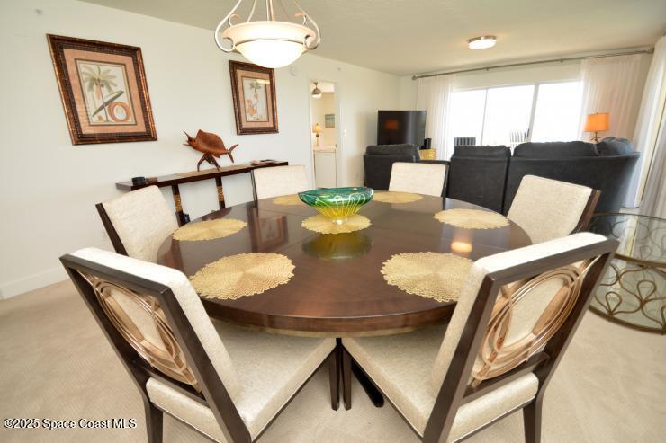 8700 Ridgewood Avenue, Unit B310 Cape Canaveral, FL 32920 - Photo 8 of 23 a living room with furniture and a table