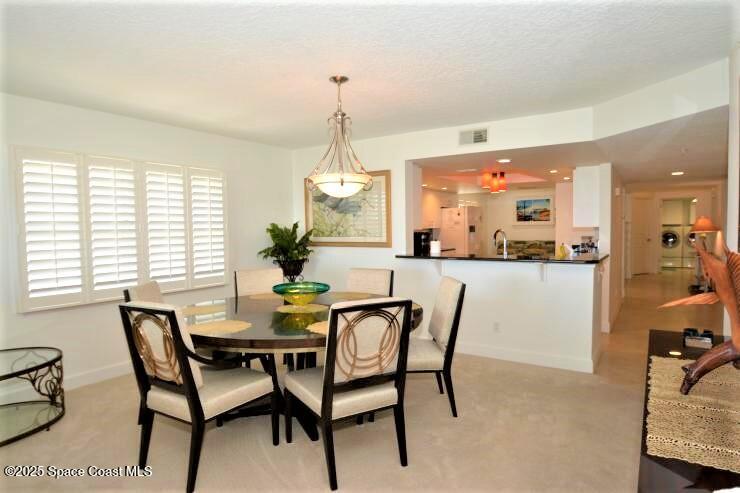 8700 Ridgewood Avenue, Unit B310 Cape Canaveral, FL 32920 - Photo 9 of 23 a dining room with furniture and window