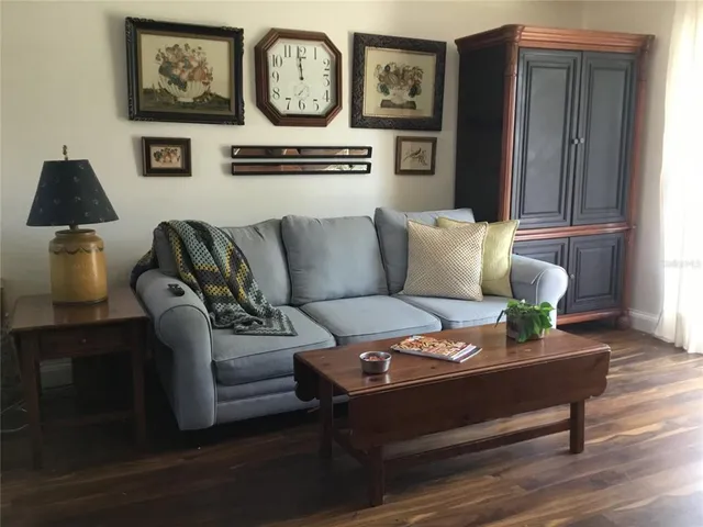 a living room with furniture and a lamp