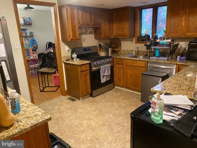 a kitchen with a sink stove and cabinets