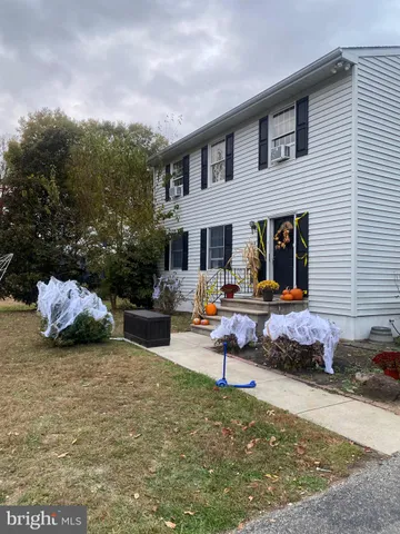 a front view of a house with sitting area