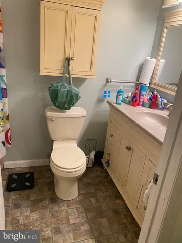 a bathroom with a toilet a sink and a window