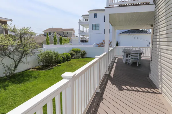 a view of house with backyard and furniture