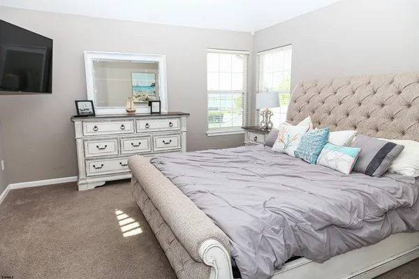 a bedroom with a bed and flat screen tv