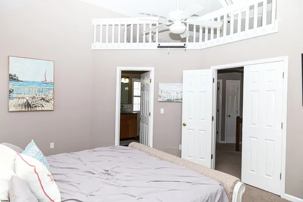 a bedroom with a bed and a potted plant