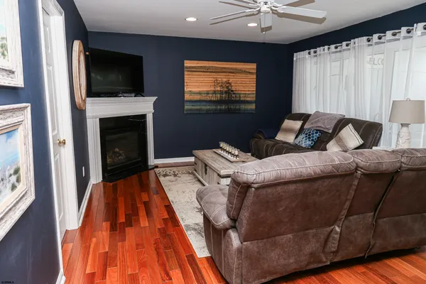 a living room with stainless steel appliances kitchen island granite countertop furniture and a view of kitchen