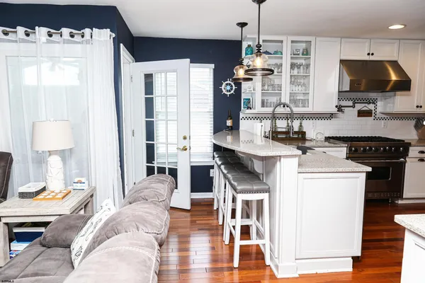 a kitchen with stainless steel appliances a center island and a wooden floor