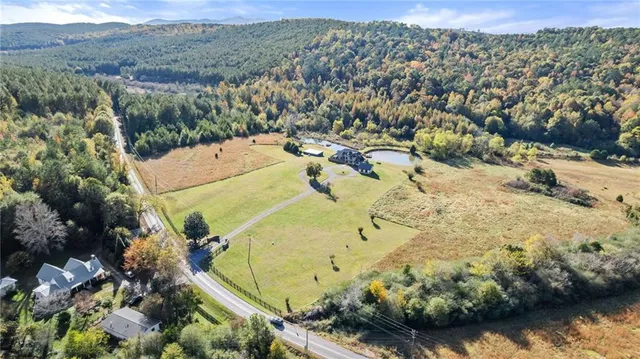 an aerial view of a house with a yard