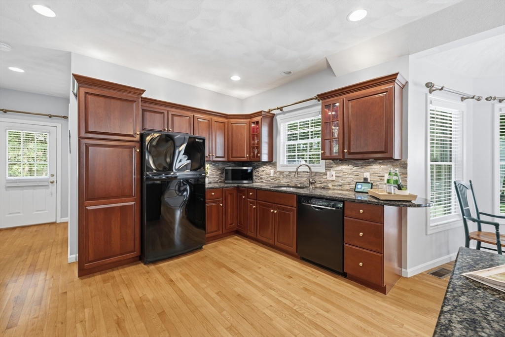 25 Haymeadow Road Boxford, MA 01921 - Photo 14 of 42 a kitchen with stainless steel appliances granite countertop a refrigerator stove and sink