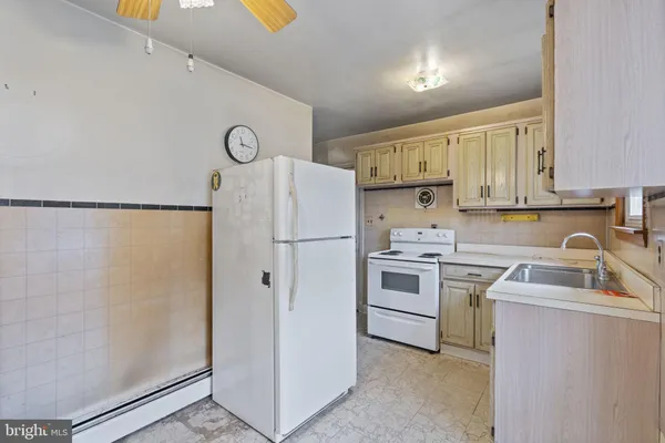 a kitchen with a refrigerator sink stove and cabinets