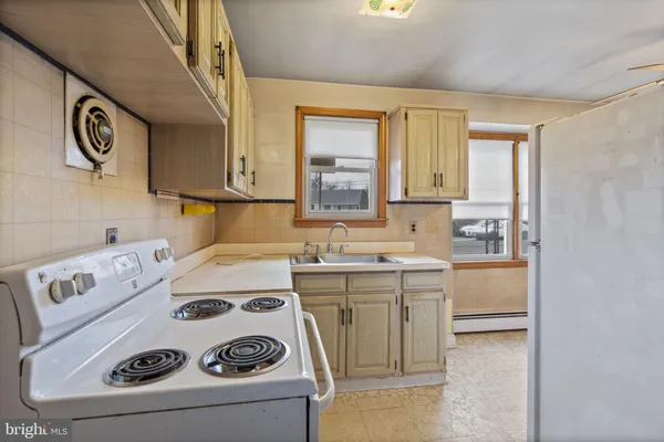 a utility room with sink dryer and washer
