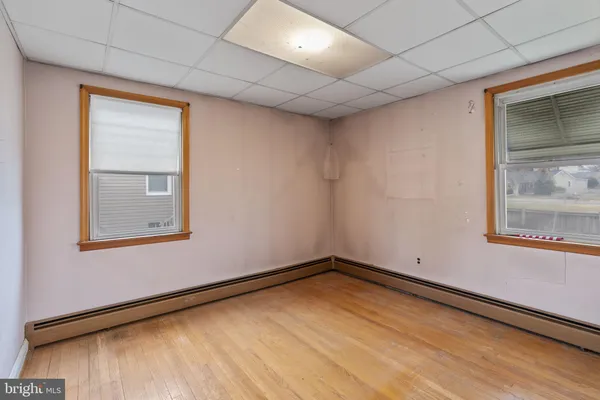 a view of a room with wooden floor and a window