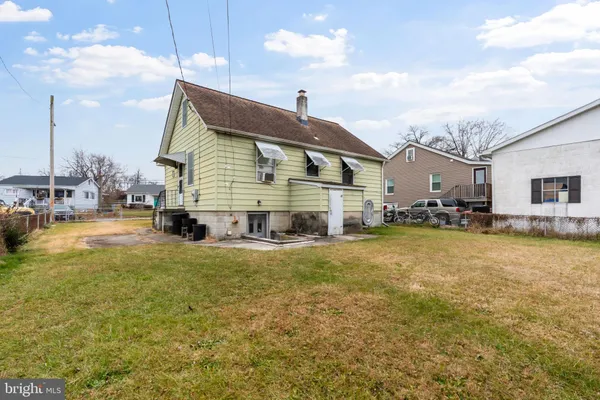a view of a house with pool and a yard