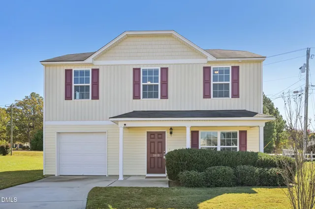 a view of house with a yard