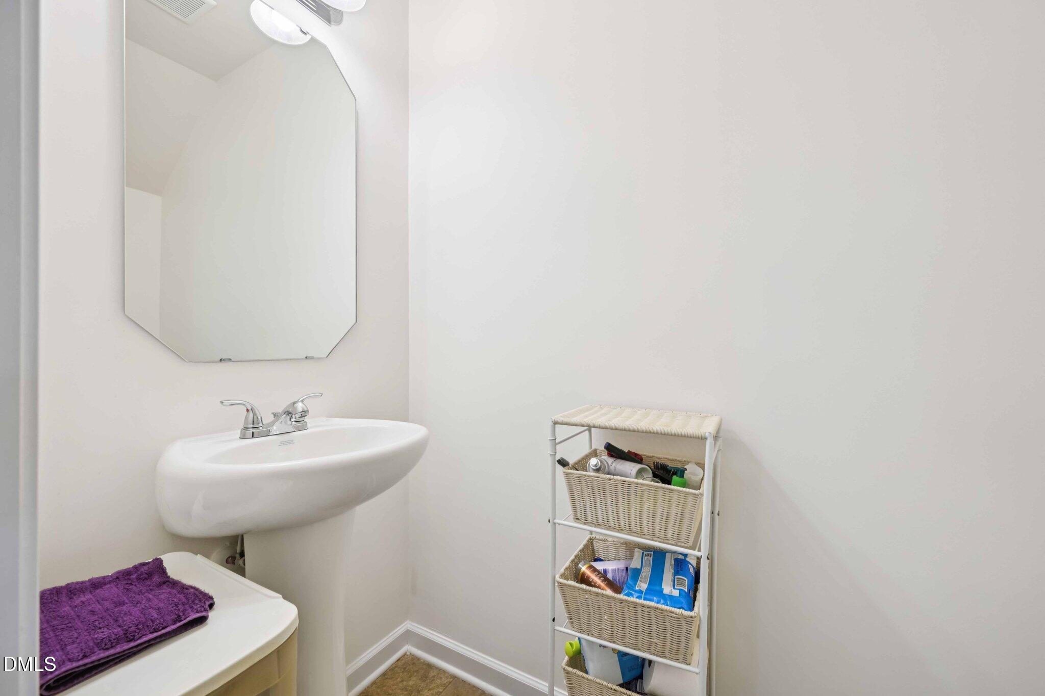2020 Creek Road Nashville, NC 27856 - Photo 11 of 26 a bathroom with a sink a mirror and a toilet