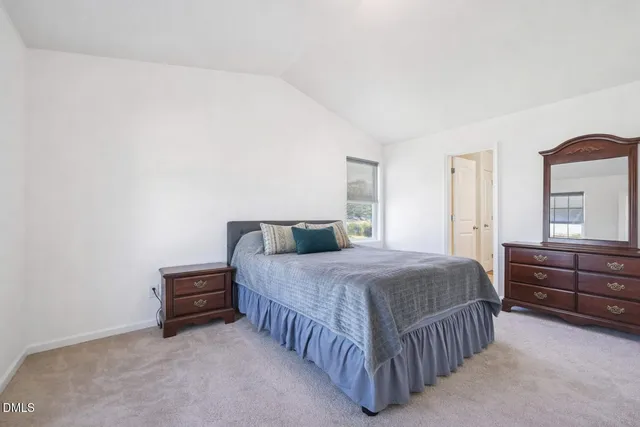 a bedroom with a bed and dresser