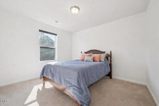 a bedroom with a bed and window