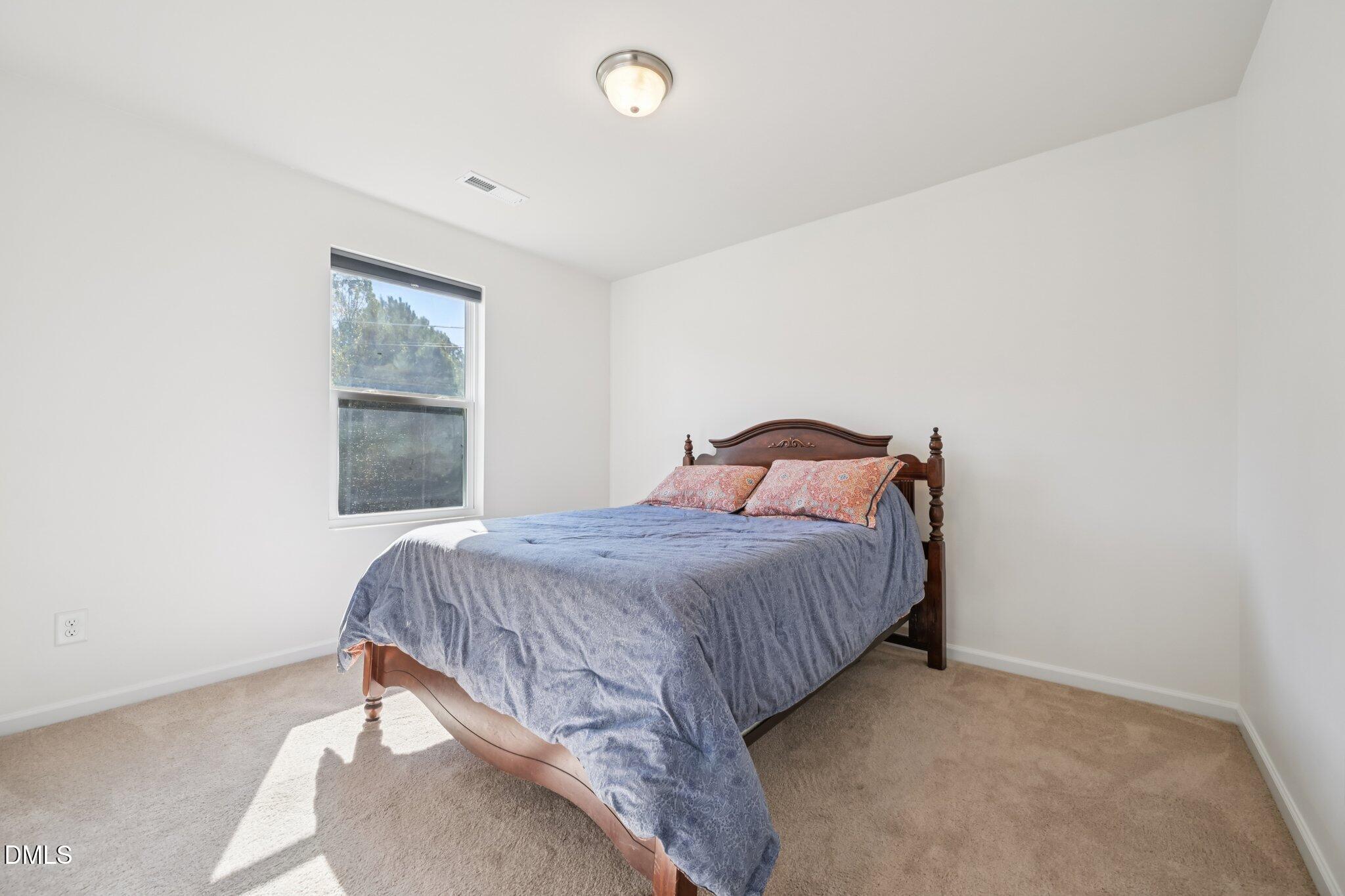 2020 Creek Road Nashville, NC 27856 - Photo 17 of 26 a bedroom with a bed and a window