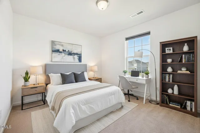 a bedroom with a bed a table and a bookshelf