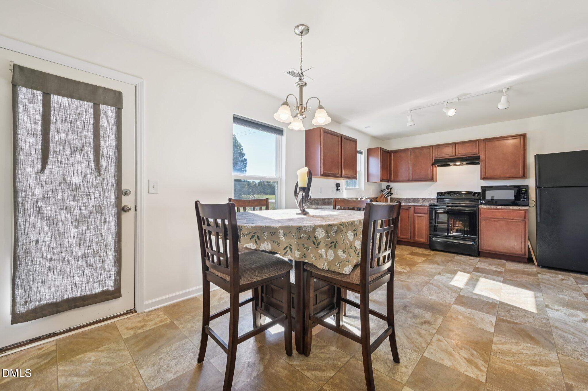 2020 Creek Road Nashville, NC 27856 - Photo 7 of 26 a view of a dining room with furniture window and wooden floor