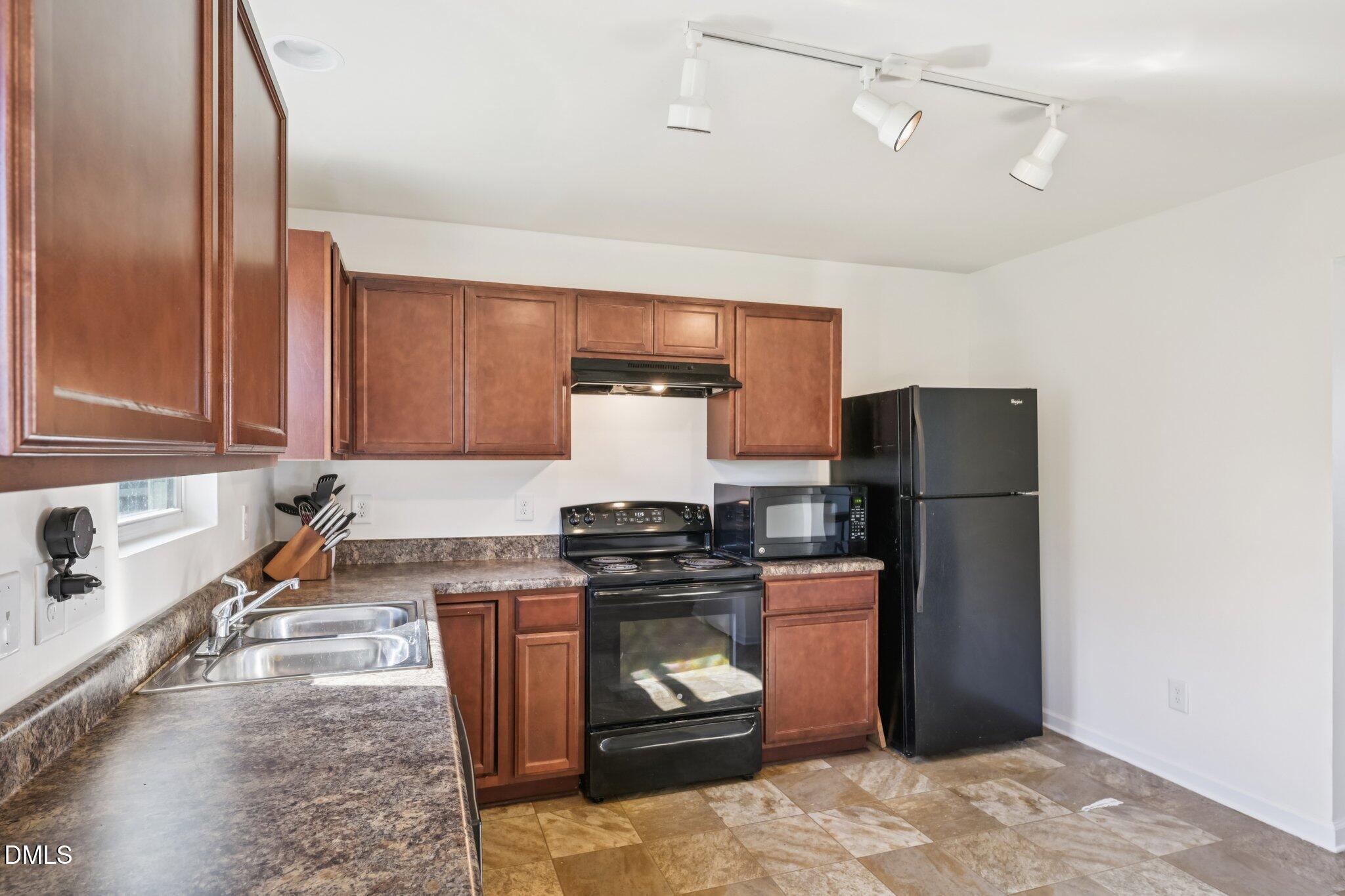 2020 Creek Road Nashville, NC 27856 - Photo 9 of 26 a kitchen with stainless steel appliances granite countertop a stove a refrigerator and a sink