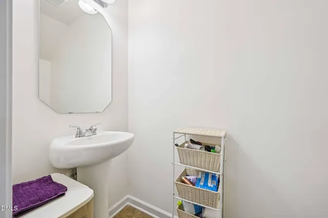 a bathroom with a sink a mirror and a toilet