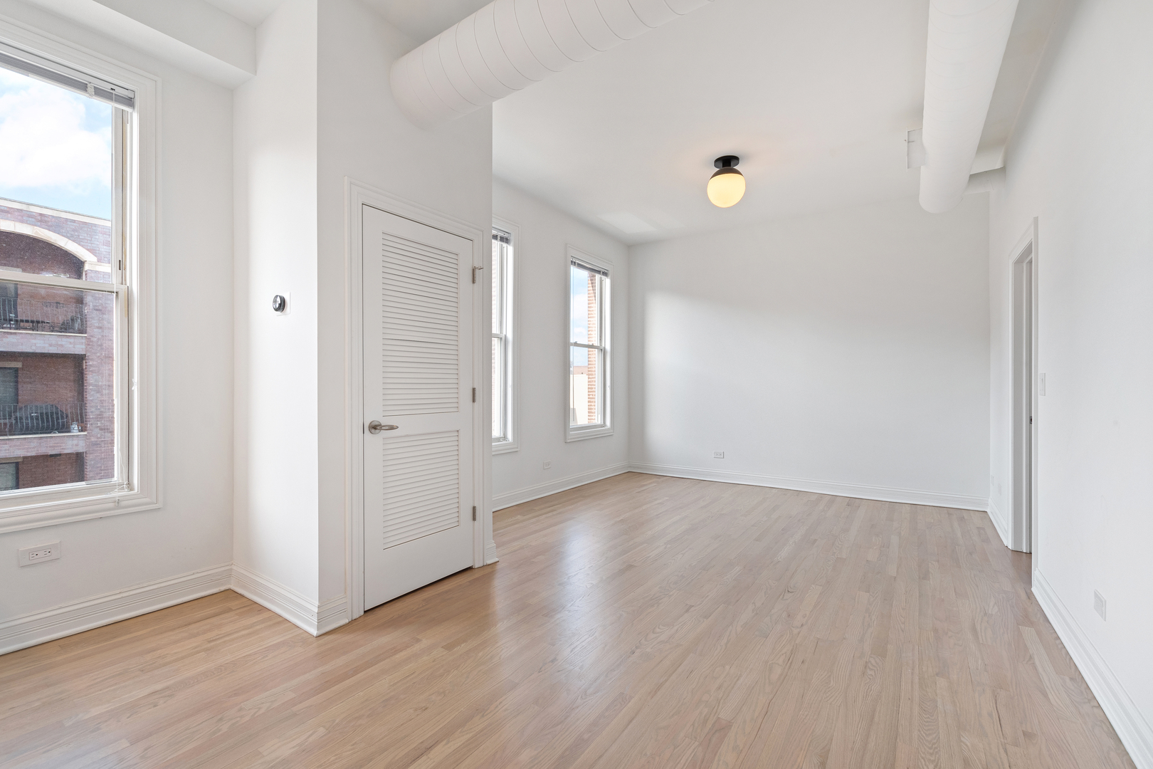 Undisclosed Address Chicago, IL 60622 - Photo 2 of 14 an empty room with wooden floor and windows