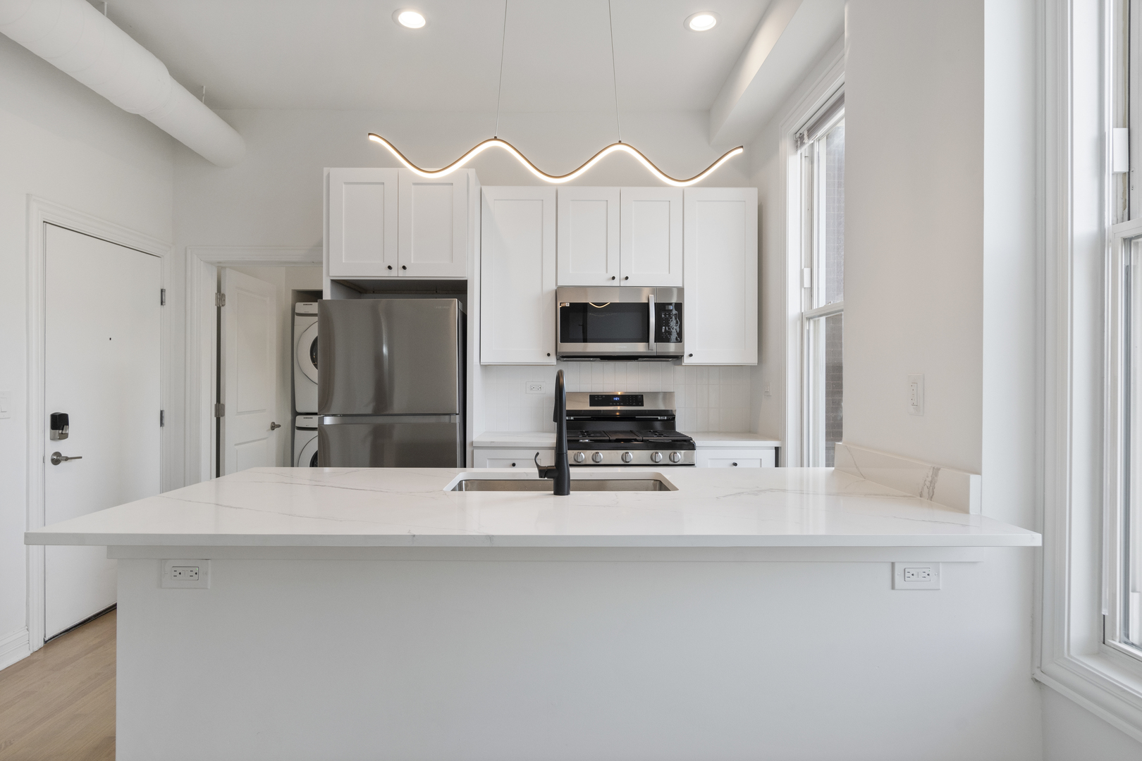 Undisclosed Address Chicago, IL 60622 - Photo 4 of 14 a kitchen with stainless steel appliances a refrigerator sink and microwave