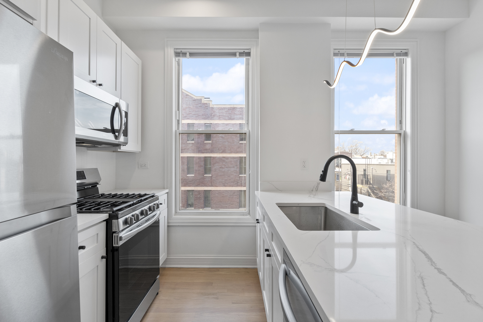 Undisclosed Address Chicago, IL 60622 - Photo 5 of 14 a kitchen with stainless steel appliances granite countertop a sink stove and refrigerator