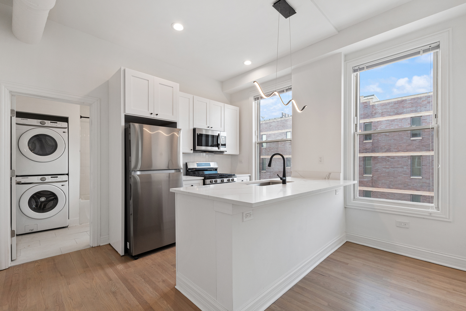 Undisclosed Address Chicago, IL 60622 - Photo 6 of 14 a kitchen with stainless steel appliances a refrigerator a sink a stove and white cabinets with wooden floor
