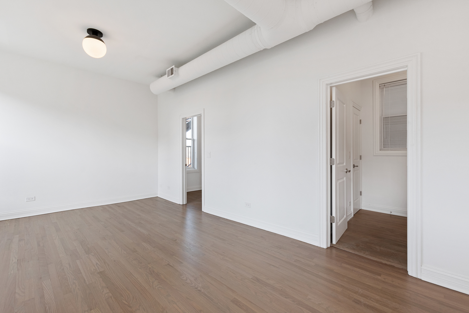 Undisclosed Address Chicago, IL 60622 - Photo 9 of 14 a view of an empty room with wooden floor