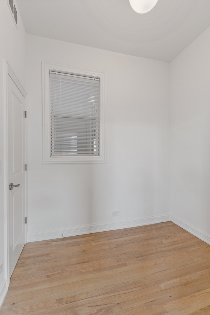 Undisclosed Address Chicago, IL 60622 - Photo 10 of 14 a view of an empty room with wooden floor and a window