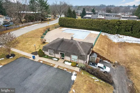 a view of a house with a yard and sitting area