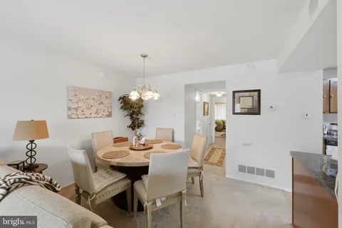 a view of a dining room with furniture and chandelier