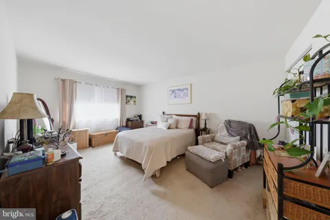 a bedroom with furniture and a potted plant