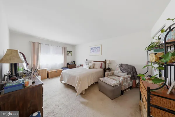 a bedroom with furniture and a potted plant