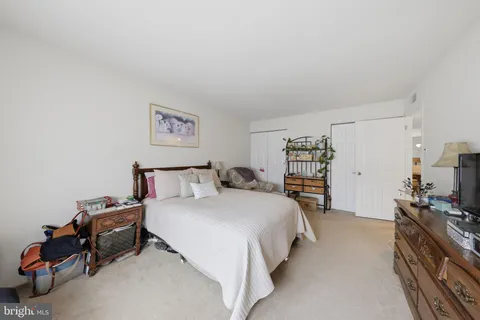 a bed room with a bed and a chair