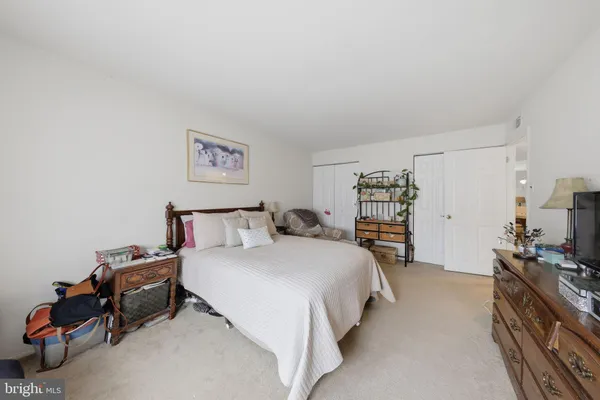 a bed room with a bed and a chair
