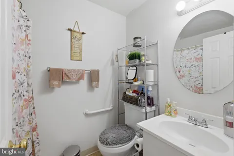 a bathroom with a sink toilet and mirror