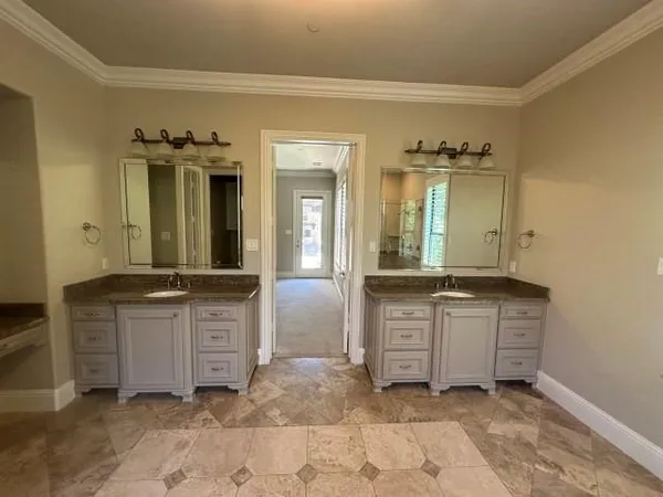a spacious bathroom with a granite countertop sink and a mirror