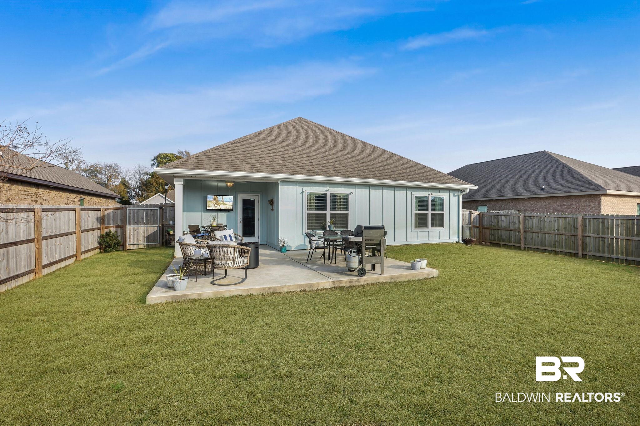 9056 Impala Drive Foley, AL 36535 - Photo 22 of 22 Back of property featuring a patio and a lawn